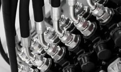 Hydraulic connectors in an industrial machine in close-up.