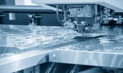 Turret punching machine cutting the metal  plate. Metal forming machine.
