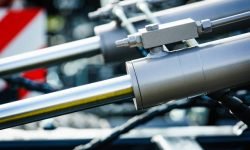 Hydraulic system on modern heavy machine. Industrial detail piston in machinery. Technology.