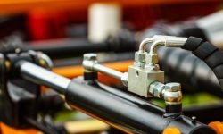 Hydraulic system on modern heavy machine. Industrial detail piston in machinery. Technology.