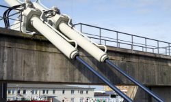Large hydraulic cylinders for moving a swing bridge over a harbor basin