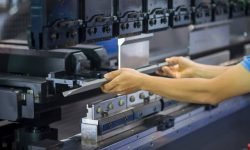 The technician operator working with hydraulic press brake bending machine. The sheet metal working operation by skill operator.
