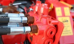 This is a detailed view that showcases the hydraulic hoses and connectors in a vibrant red hydraulic system