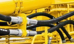 hydraulics pipes and nozzles, tractor or other construction equipment. focus on the hydraulic pipes
