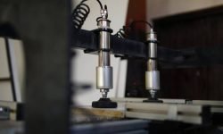 Hydraulic press of an industrial wood drill machine.